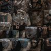 A close-up vertical shot showcasing various intricately designed handbags on display at a market stall.