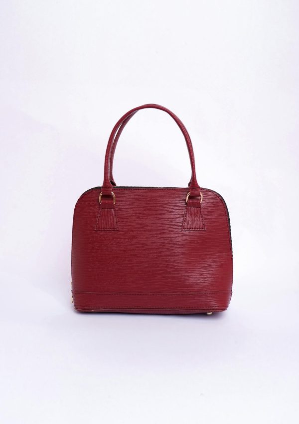 Stylish red leather handbag with handles on a clean white background, perfect for fashion enthusiasts.