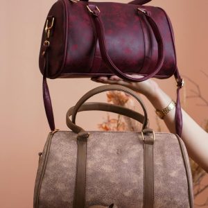 Two stylish handbags beautifully displayed in a retail setting, showcasing elegance and fashion.
